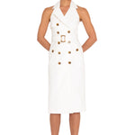 Woman wearing a white trench dress with buttons on a white background